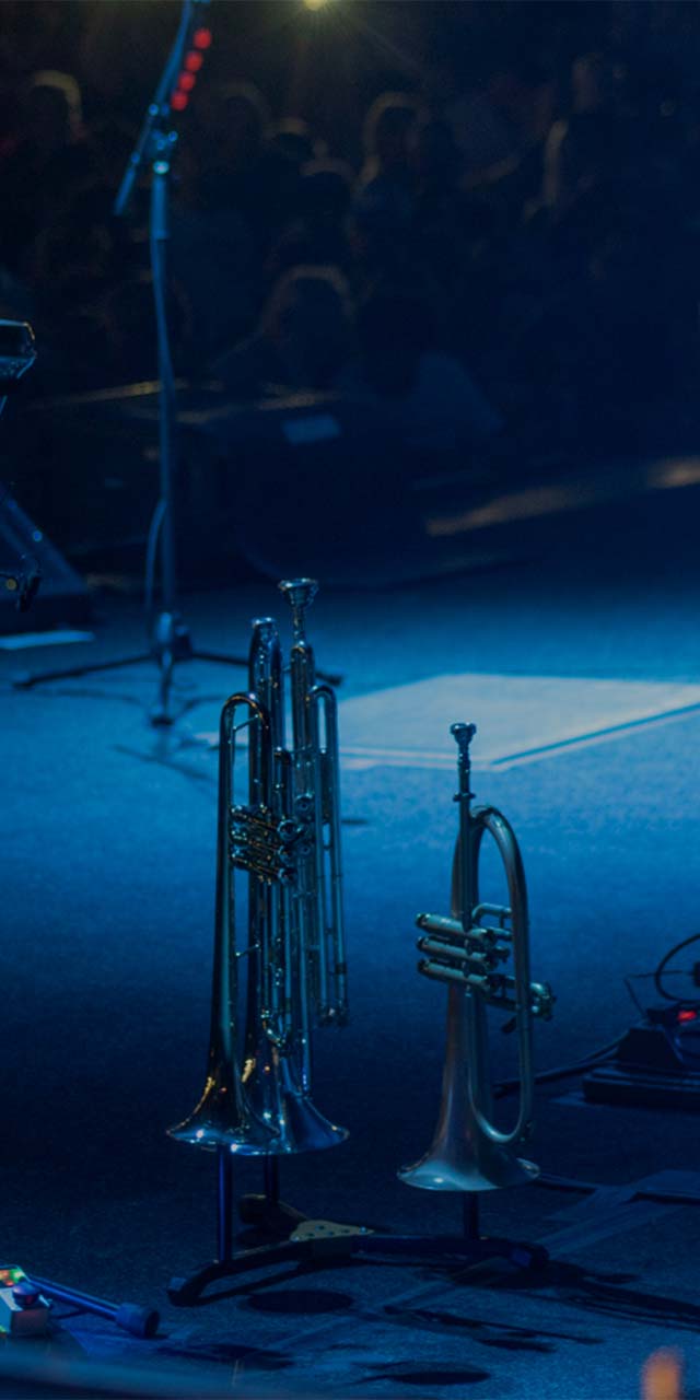 A Cornet on stage covered in blue light